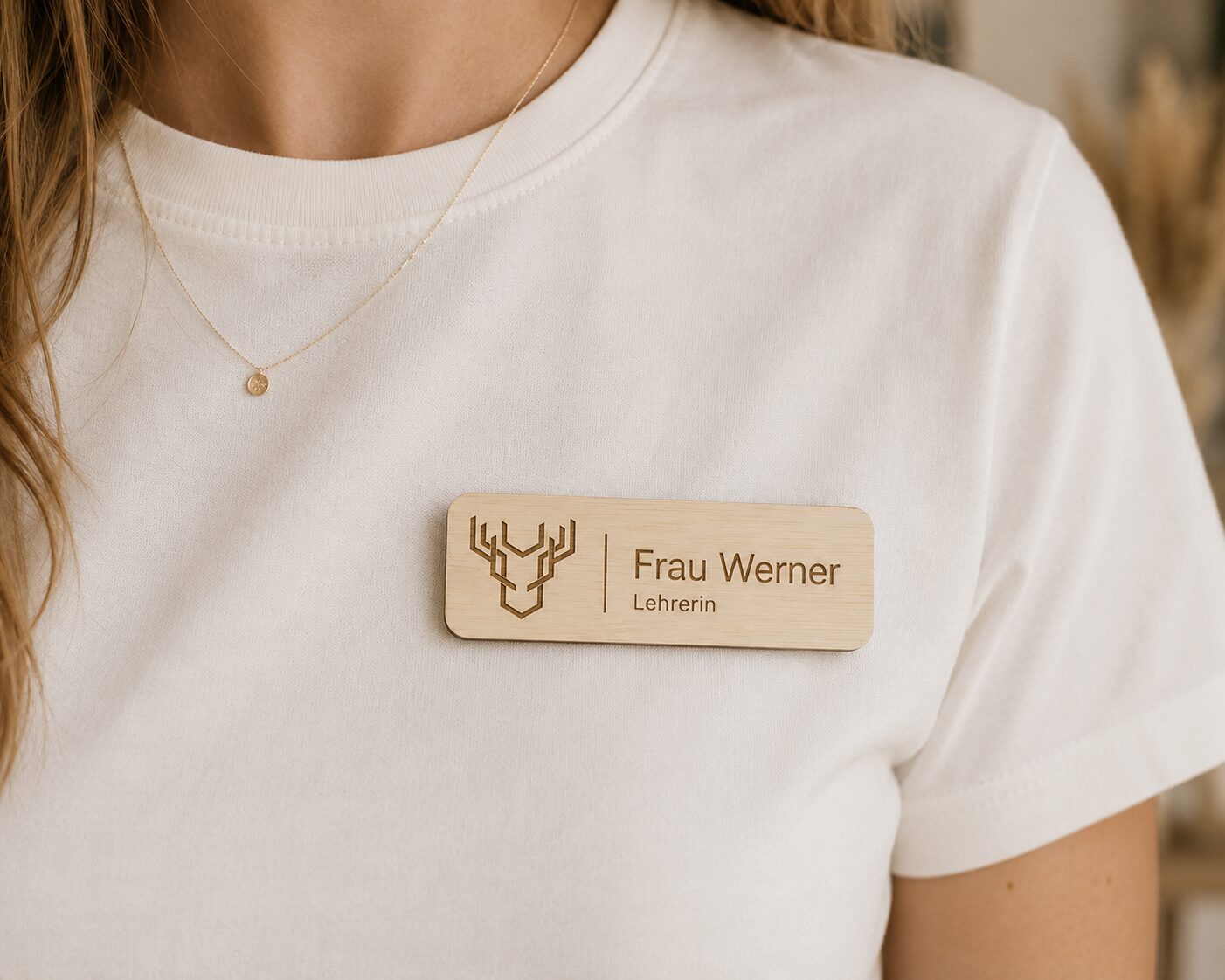 Namensschild aus Holz mit Namen und Logo an einem Hemd